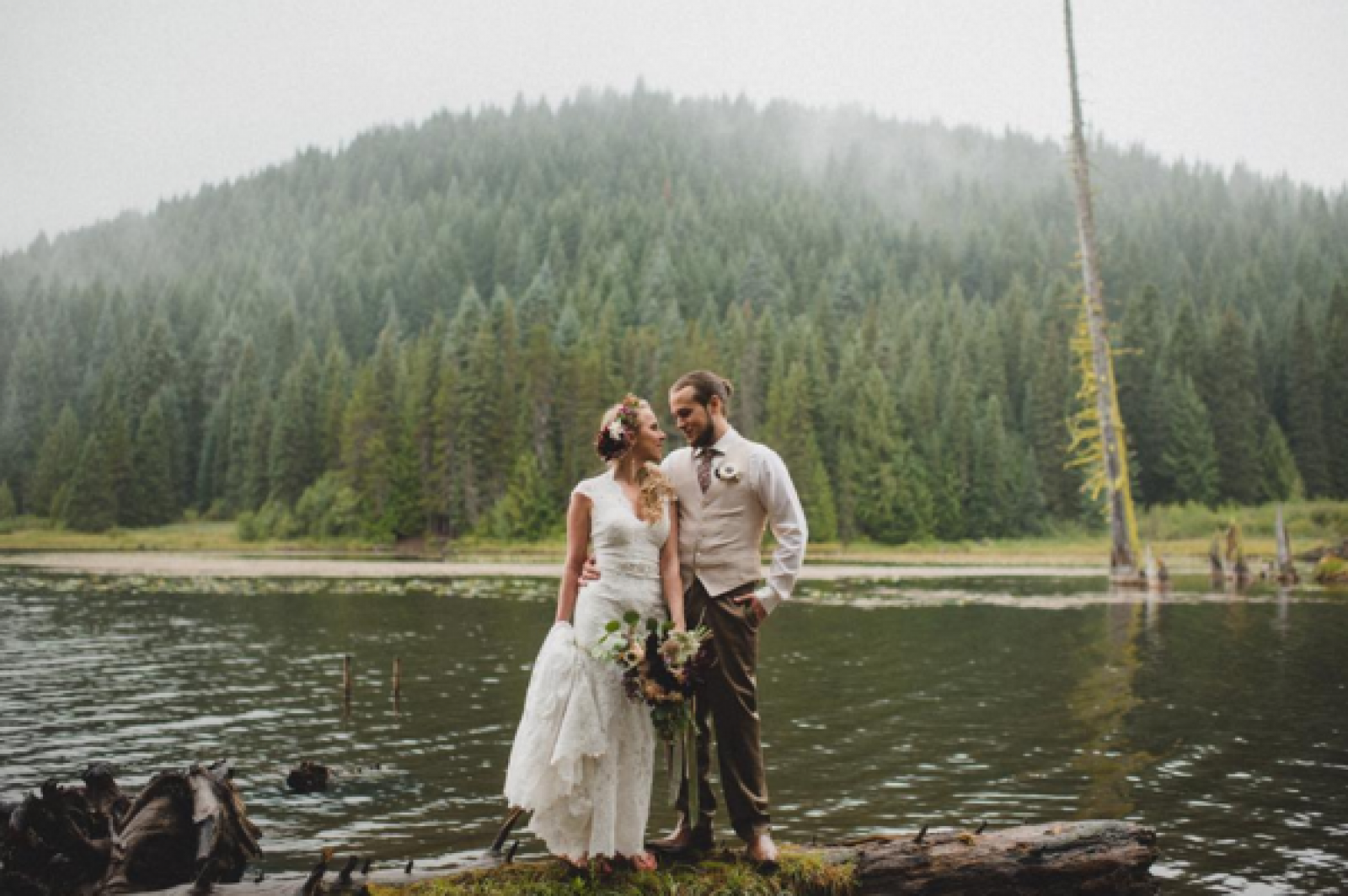 couple posting by lake