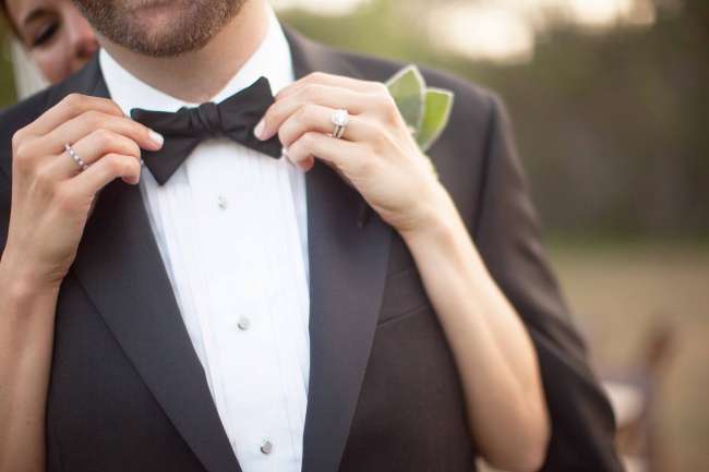 Bride Adjusting Groom's Bow Tie