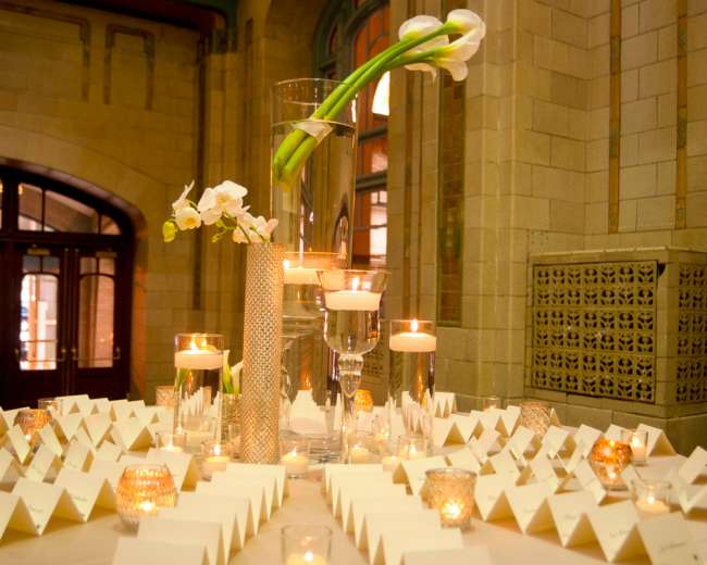 Tall Floral Centerpieces on Table With Name Cards