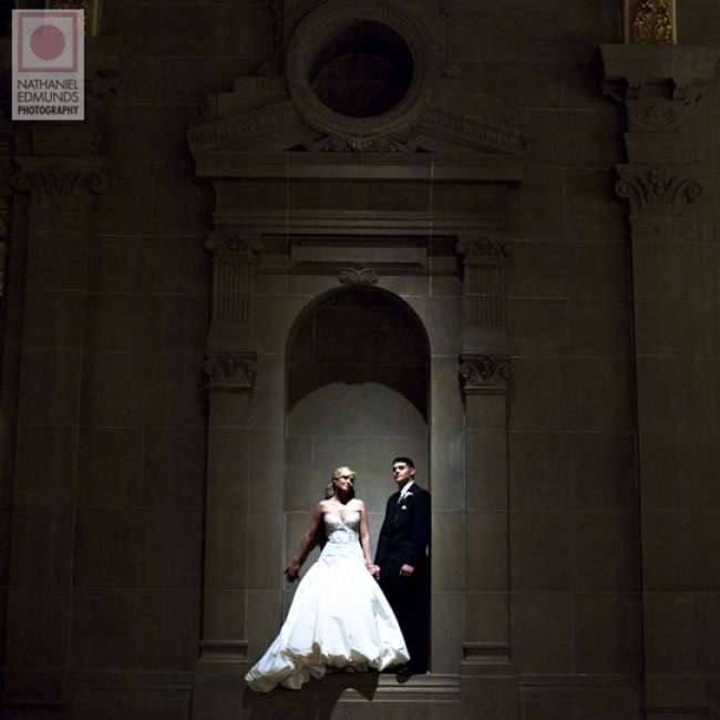 Bride and groom pose in historic building