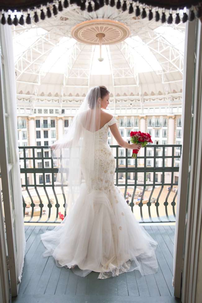 Bride poses on balcony