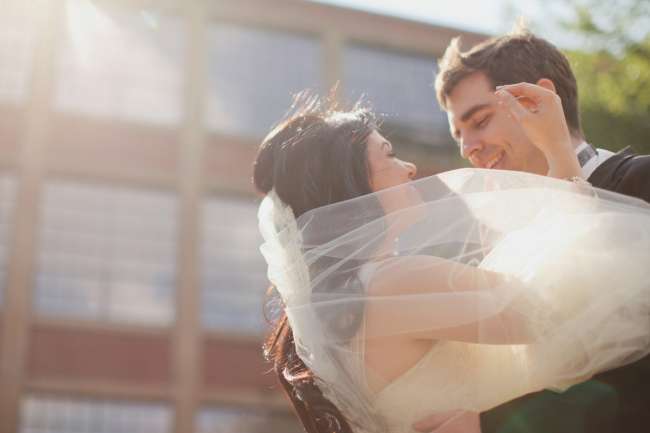 Bride's Veil Blows Around Bride & Groom