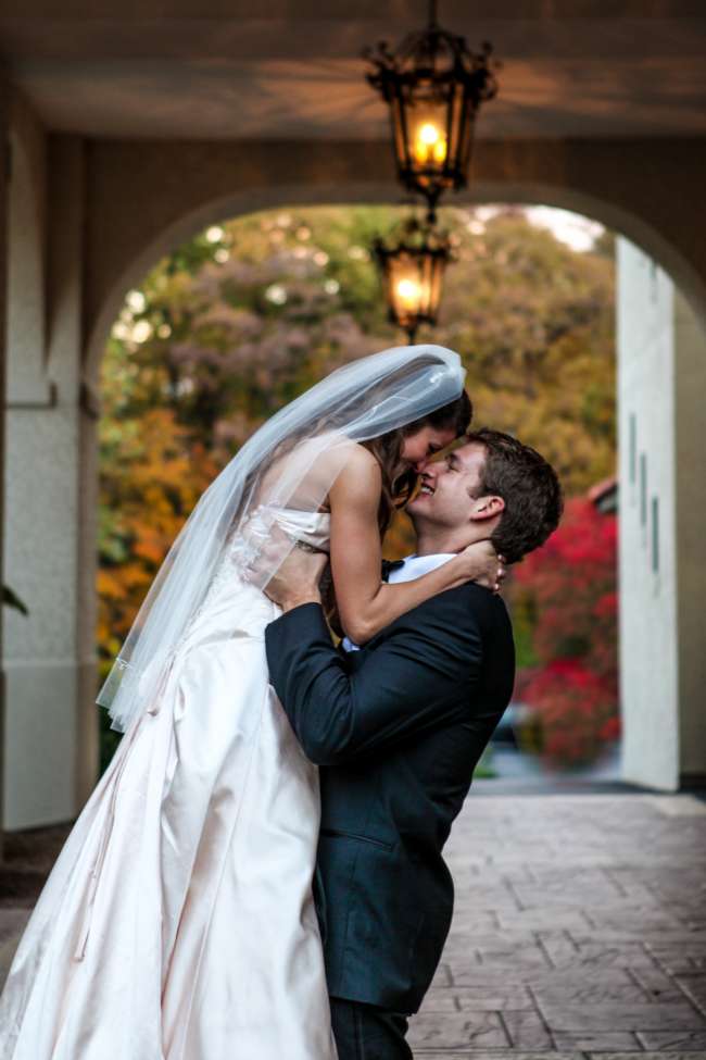 Groom Lifts Bride Up at Fall Wedding