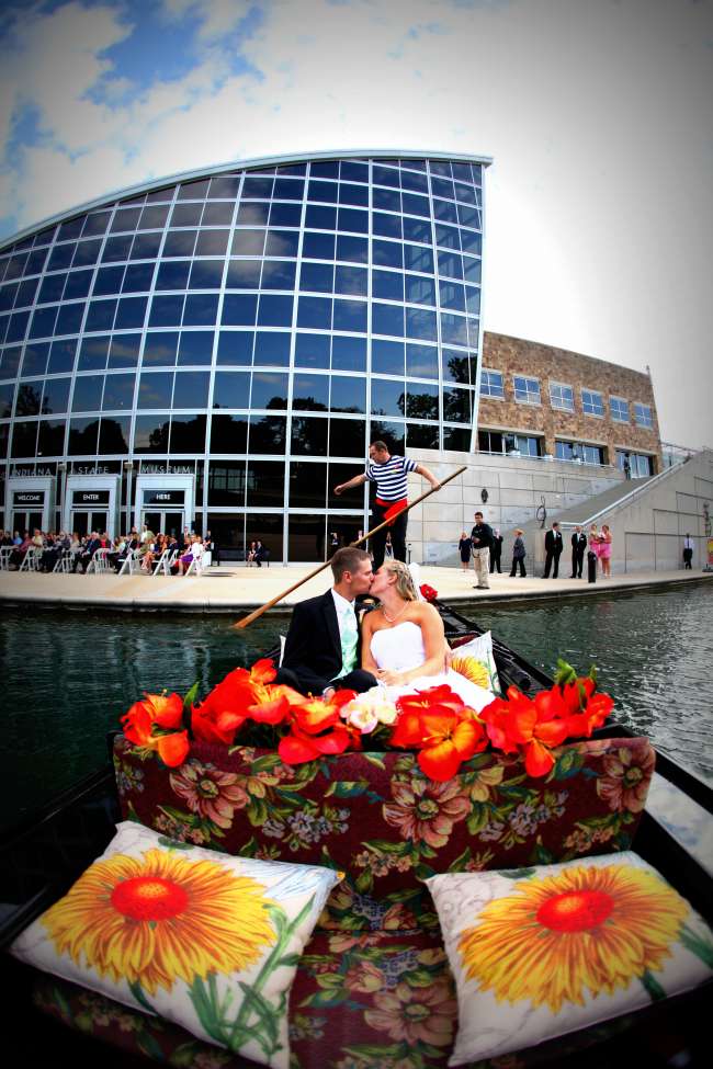 Bride and groom kissing in gondola