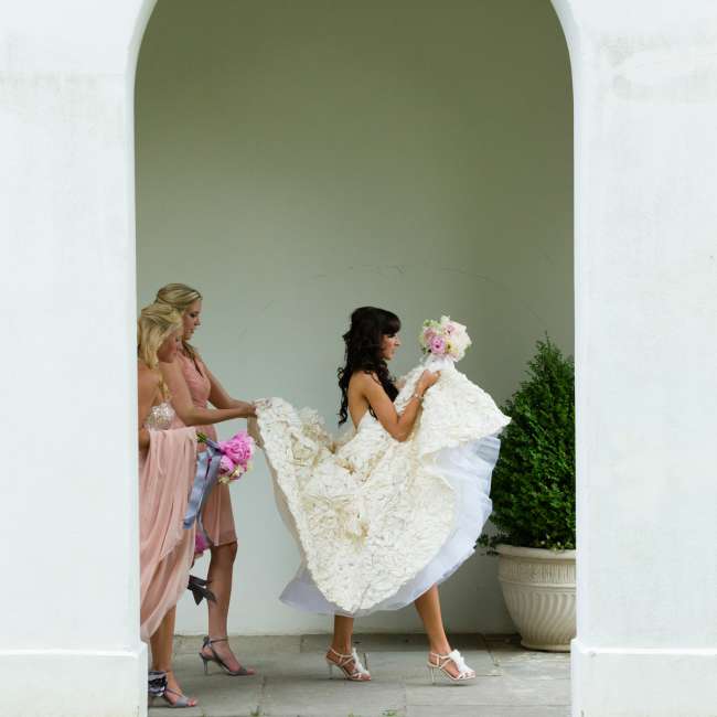 Bridesmaids Helping Hold the Bride's Dress