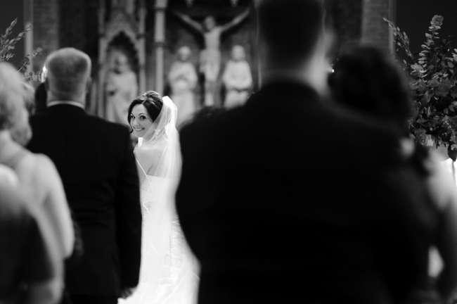 Bride Peeks Through Crowd at Ceremony