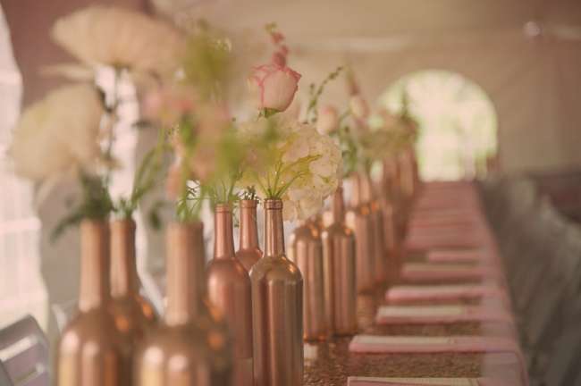Spray painted wine bottles are used for vases